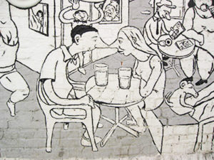 Mural in Oslo, Norway of two cartoon characters sitting at a busy cafe